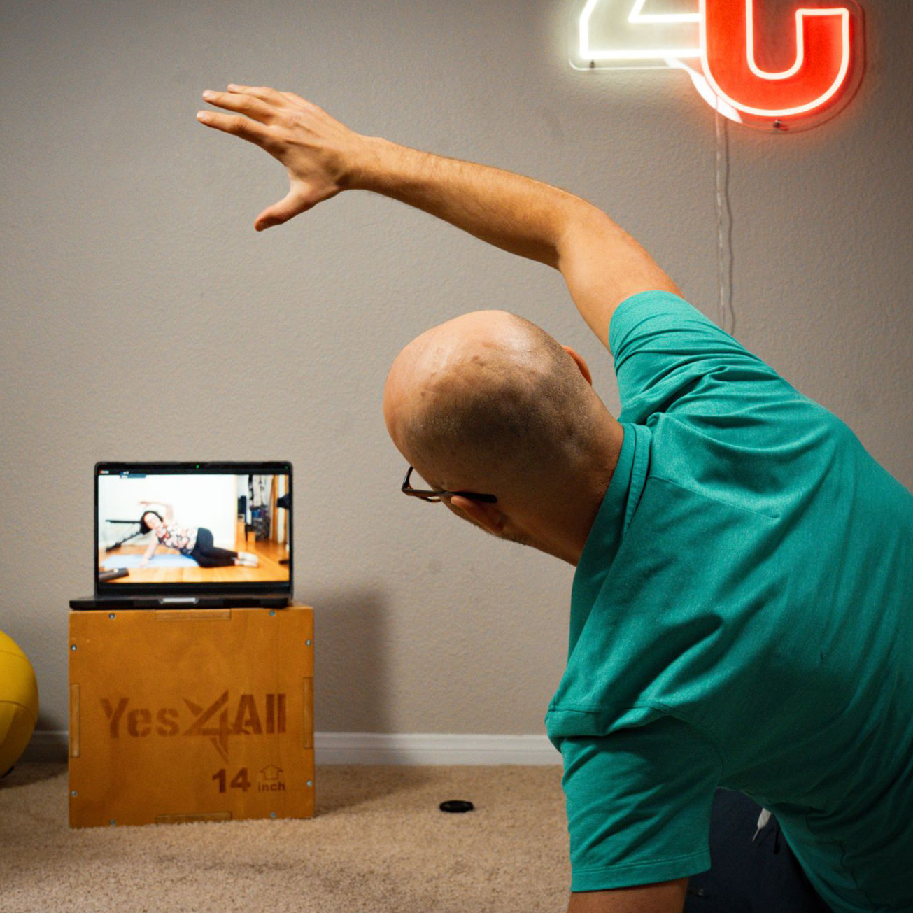 Coach demonstrating a movement drill during a remote coaching session